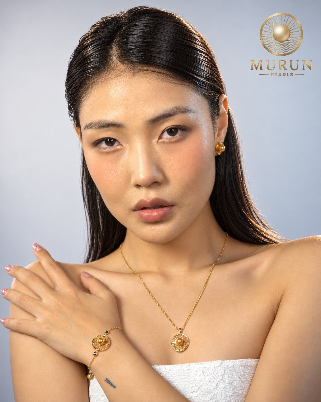 Murun Pearls Limited Edition emblem pendant, bracelet and earrings in gold with golden South Sea pearls, worn by a model