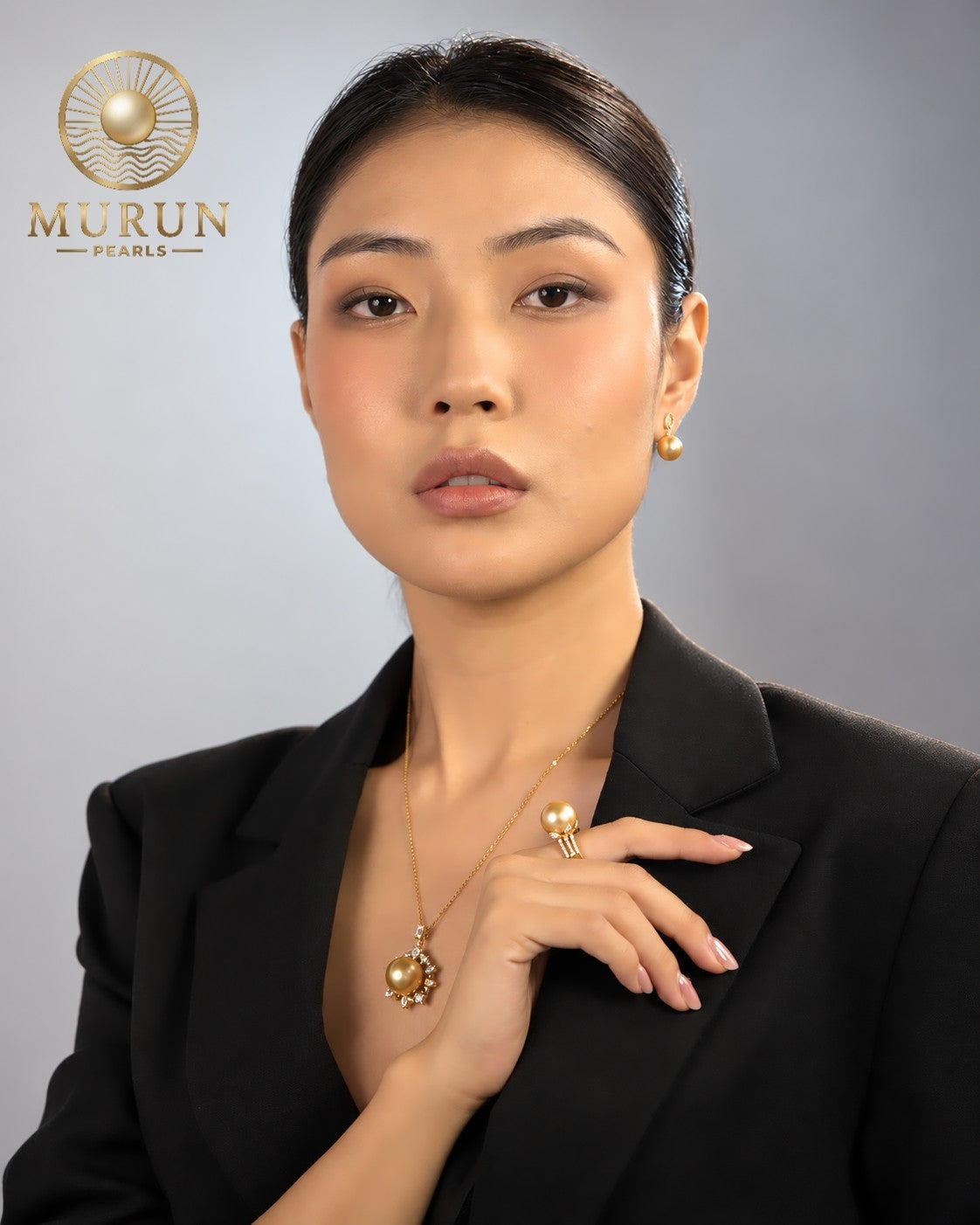 Golden South Sea pearl pendant, ring and earrings from the Murun Pearls Limited Edition, worn with a black blazer